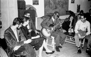 Reverend Gary Davis entertains guests at a party for his 63rd birthday, in 1959