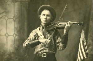 Eck Robertson with Fiddle and Flag .Source from the Country Music Hall of fame