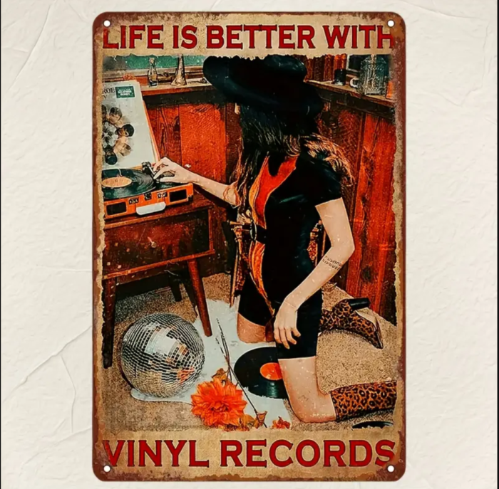 Small tin wall hanging with a teenage girl wearing a witch’s hat, playing vinyl records. The text reads: ‘Life is Better with Vinyl Records.