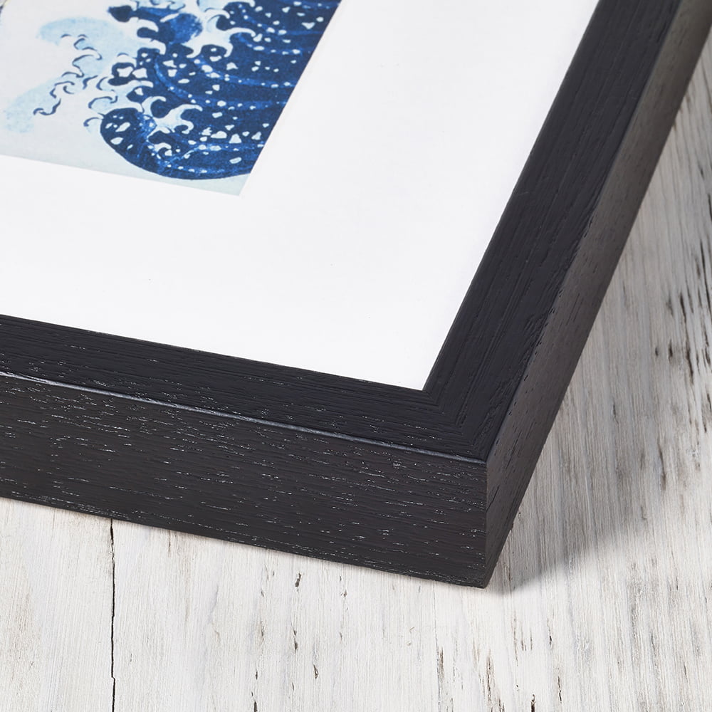 Box Frame Detail: "Close-up of a sleek black box frame showcasing its elegant design and wood grain texture."