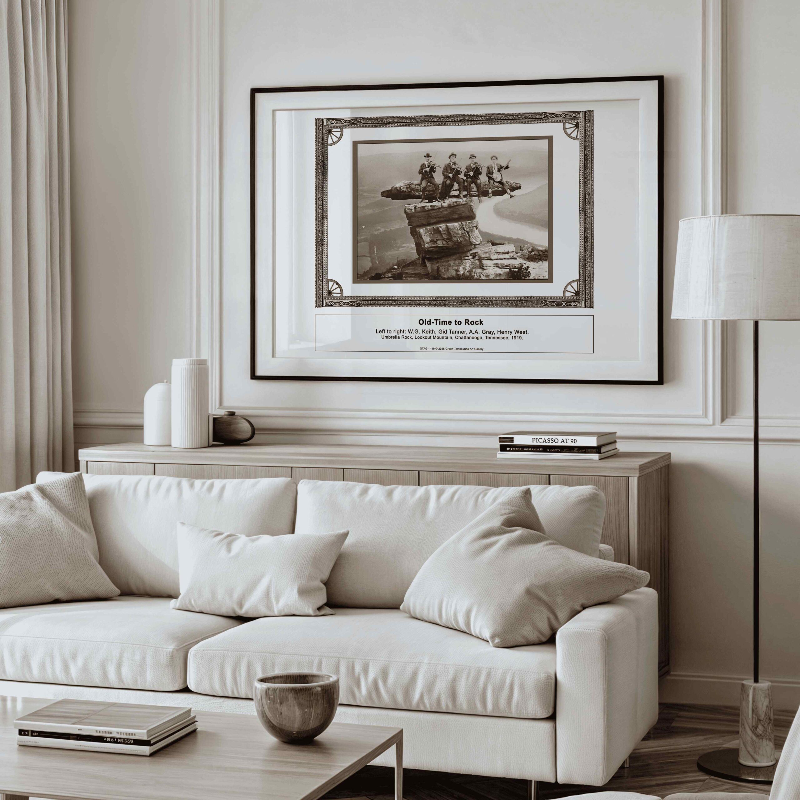 "A framed A3 fine art print titled Old Time Musicians – WG. Keith, Gid Tanner, AA Gray, Henry West – 1919, Lookout Mountain Print (SKU: GTAG-119) displayed in a modern, minimalist living room above a neutral-colored sofa. The black and white vintage-style artwork, elegantly framed, adds a historical touch to the refined décor."