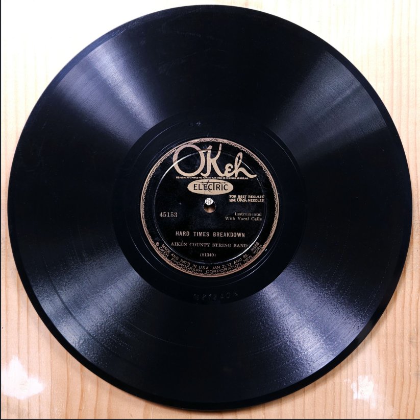 Vintage 78rpm OKeh record of Hard Times Breakdown by the Aiken County String Band, photographed on a wooden surface
