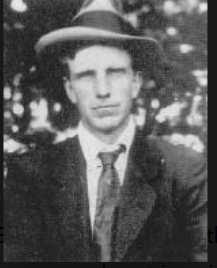 Black and white portrait of Wilburn Edison Nuckolls, old-time musician from North Carolina, wearing a wide-brimmed hat and suit